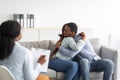 Happy black couple hugging in counselor's office after successful marital therapy Royalty Free Stock Photo