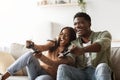 Happy black couple playing video games at home Royalty Free Stock Photo