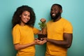 Happy couple protect a small tree. Concept of forestation, ecology and conservation Royalty Free Stock Photo