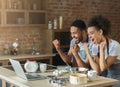 Happy black couple cooking pastry looking on laptop Royalty Free Stock Photo