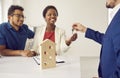 Realtor or real estate agent gives keys to new house to happy young black couple Royalty Free Stock Photo