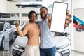 Happy Black Couple Standing Near New Car And Showing Blank Smartphone Royalty Free Stock Photo