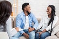 Happy black couple after successful marital therapy with psychologist