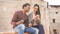 Happy black couple using smartphone outddor during holiday vacation - Young boyfriend and girlfriend having fun with technology