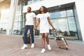 Happy black couple walking in front of airport terminal building Royalty Free Stock Photo