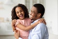 Happy black dad hugging with his laughing little daughter Royalty Free Stock Photo