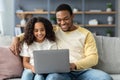 Happy black dad showing his daughter how to use computer Royalty Free Stock Photo