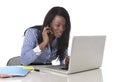 Happy black ethnicity woman working at computer laptop and mobile phone relaxed