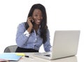 Happy black ethnicity woman working at computer laptop and mobile phone relaxed Royalty Free Stock Photo