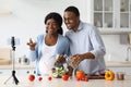 Happy black expecting family broadcasting while cooking Royalty Free Stock Photo