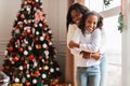 Happy black family celebrating Christmas and hugging Royalty Free Stock Photo