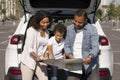 Happy black family going car trip together, checking map Royalty Free Stock Photo