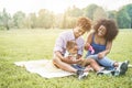 Happy black family having fun doing picnic outdoor - Parents and their daughter enjoying time together in a weekend day - Love