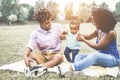 Happy black family having fun doing picnic outdoor - Parents and their daughter enjoying time together in a weekend day - Love Royalty Free Stock Photo