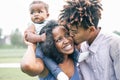 Happy black family having fun in a park outdoor - Mother and father with their daughter enjoying time together in a weekend day Royalty Free Stock Photo