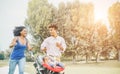 Happy black family having fun running in public park outdoor - Parents and their daughter enjoying time together - Love, tender