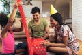 Happy black family at home. African american father, mother and child celebrating birthday, having fun at party. Royalty Free Stock Photo
