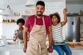 Happy black family in the kitchen having fun and cooking together. Healthy food at home. Royalty Free Stock Photo