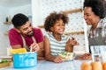 Happy black family in the kitchen having fun and cooking together. Healthy food at home. Royalty Free Stock Photo