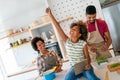 Happy black family in the kitchen having fun and cooking together. Healthy food at home. Royalty Free Stock Photo