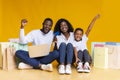 Happy black family with laptop, credit card and shopping bags. Royalty Free Stock Photo