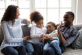 Happy black family laughing playing tickling children at home Royalty Free Stock Photo