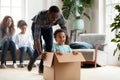 Happy black family play with kids moving to new home Royalty Free Stock Photo