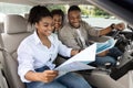 Happy Black Family Sitting In Car Looking At Road Map Royalty Free Stock Photo