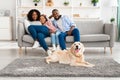 Happy black family sitting in living room with dog Royalty Free Stock Photo