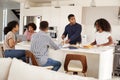 Happy African American  family at their kitchen island, talking and preparing a family meal together Royalty Free Stock Photo