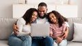 Happy black family using laptop in living room Royalty Free Stock Photo