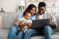 Happy black family using laptop in living room Royalty Free Stock Photo