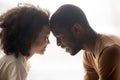 Happy black father and cute mixed-race kid daughter touching foreheads Royalty Free Stock Photo