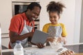 Happy Black Father And Daughter Using Digital Tablet In Kitchen While Baking Royalty Free Stock Photo