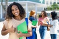 Happy black female student with group of latin american and caucasian young adults Royalty Free Stock Photo