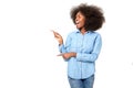 Happy black girl with afro pointing fingers at copy space