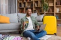 Happy black guy with credit card booking vacation or making hotel reservation online, using laptop, sitting at home Royalty Free Stock Photo