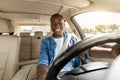 Happy black guy driving his new car, going to job Royalty Free Stock Photo