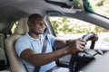 Happy black guy enjoying his new auto