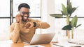 Happy black guy looking at watch talking on phone Royalty Free Stock Photo