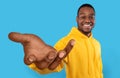 Happy black guy showing big outstretched hand, offering help, taking or giving something, reaching out for support Royalty Free Stock Photo