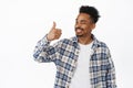 Happy Black hipster guy, african american young man shows thumb up in approval, smiling pleased and nod, praise smth Royalty Free Stock Photo