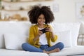 Happy black kid playing video games on mobile phone Royalty Free Stock Photo