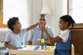 Happy Black kids playing together building high plastic tower Royalty Free Stock Photo