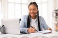 Happy black lady student studying with laptop at home Royalty Free Stock Photo