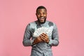 Happy black man in african shirt holding bunch of money