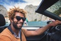 Happy black man driving a convertible car. Royalty Free Stock Photo