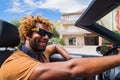Happy black man driving a convertible car. Royalty Free Stock Photo