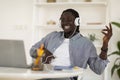 Happy Black Man In Headphones Listening Music Online With Laptop Royalty Free Stock Photo