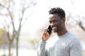 Happy black man talking on smart phone in a park Royalty Free Stock Photo